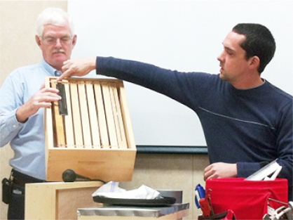 Trevor Qualls (on the right) during a beekeeping demonstration